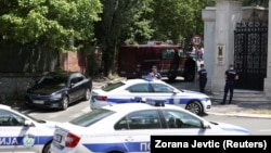 Serbian police officers outside the Israeli Embassy in Belgrade where an attacker was shot dead after attacking a police officer with a crossbow on June 29.