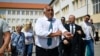Former Bulgarian Prime Minister Boyko Borisov leaves a polling station after casting his ballot during the snap parliamentary and European Parliament elections at a polling station in Sofia on June 9.