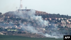A photo taken from southern Lebanon shows smoke billowing in the northern Israeli town of Metulla from cross-border rockets launched from the Lebanese side on June 26. 