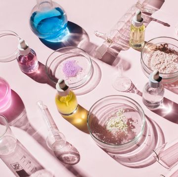 colorful background with laboratory utensils, samples of cosmetics and glass vials on pink background natural medicine, cosmetic research, bio science, organic skin care products top view, flat lay