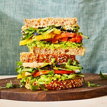veggie sandwich with avocado, tomato, cucumber, and greens