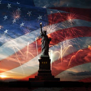 statue of liberty on the background of flag usa, sunrise and fireworks