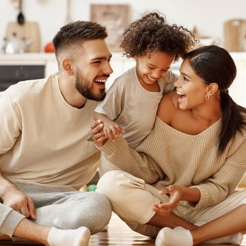 happy multiethnic family mom, dad and child laughing, playing