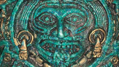 Mexican Aztec turquoise god or symbol with gold accents from the center of the Aztec or Mayan calendar