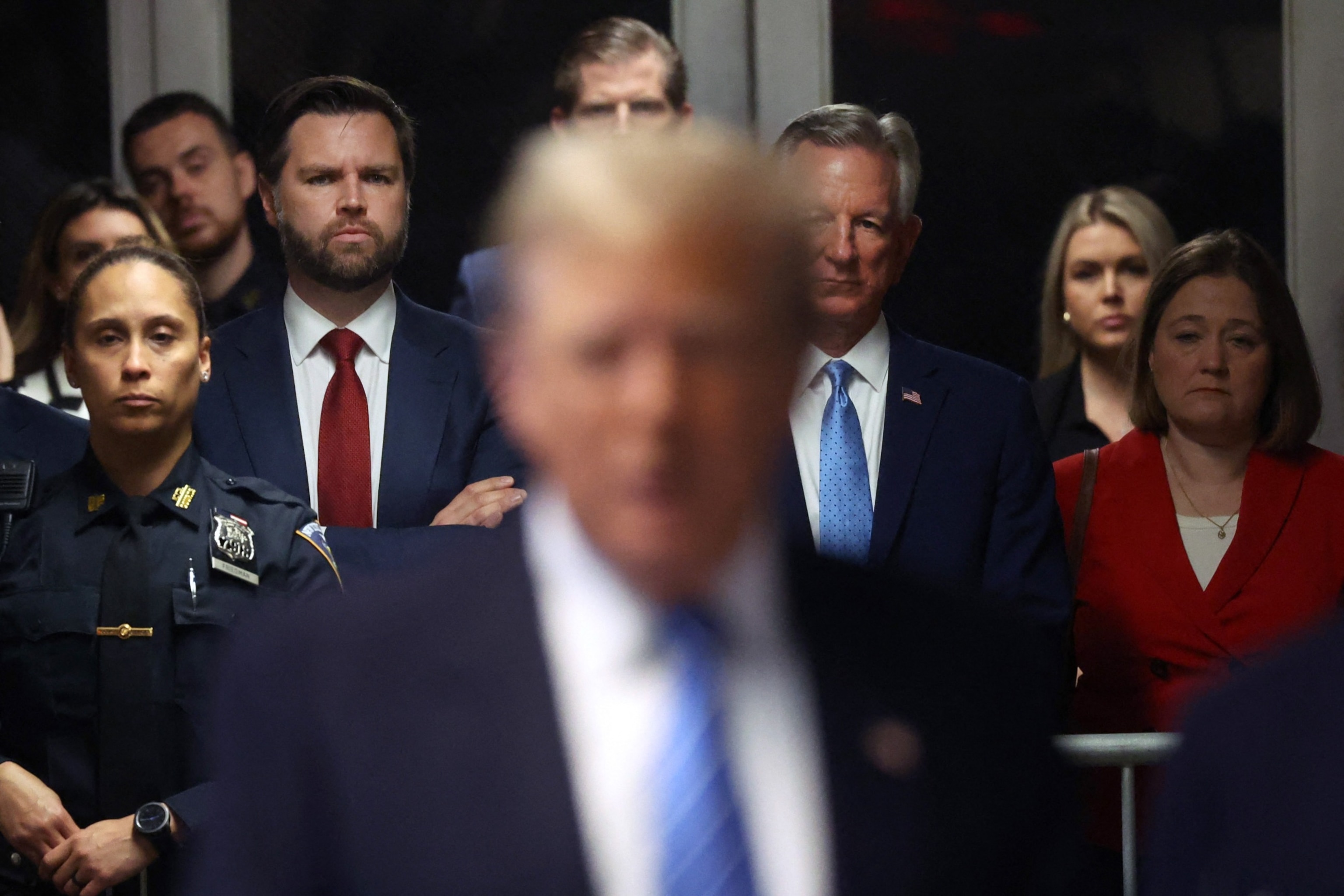 PHOTO: Senator J.D. Vance (left, red tie)(R-OH) looks on as former US President Donald Trump speaks to the media at his trial for allegedly covering up hush money payments at Manhattan Criminal Court, in New York City, on May 13, 2024. 