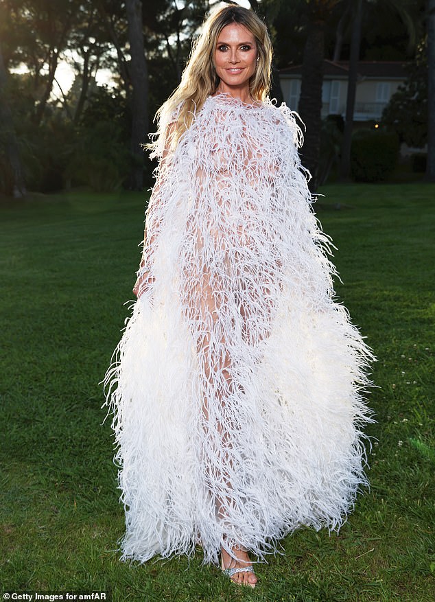 Heidi Klum, 50, went nude under a semi-sheer white feathery gown on Thursday at the amfAR Cinema Against AIDS Gala for Cannes Film Festival