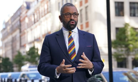 James Cleverly speaking to reporters on a street in London