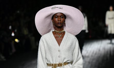 A catwalk model wears an oversized brimmed hat