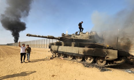 A destroyed Israeli tank at the border fence between Israel and the Gaza Strip