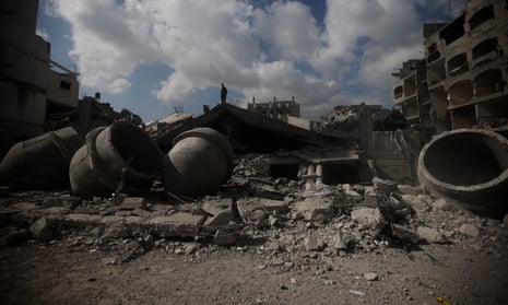 A Palestinian stands on top of a mosque destroyed in an Israeli strike in Rafah, southern Gaza