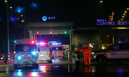 Ambulance vehicles transport passengers injured on a flight from London to Singapore on Tuesday.