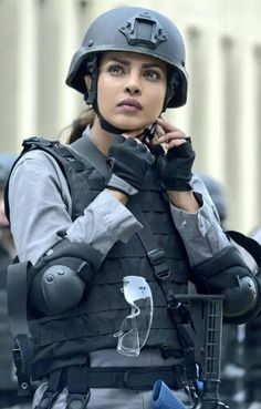 a woman in uniform is talking on her cell phone