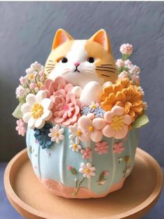 a cake decorated with flowers and a cat