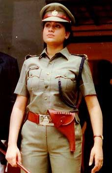a woman in uniform standing next to a man