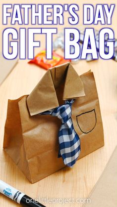 These DIY Father's Day gift bags are SO CUTE and such a great craft for Father's Day. Both kids and adults will love making this fun paper bag craft for Dad or Grandpa. You only need a paper sandwich bag and a piece of ribbon!