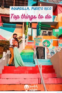 a man and woman are standing on the stairs in front of a colorful building that says top things to do