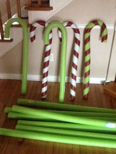 pool noodle candy canes  made with pool noodles & wire hangers. make straight wire hanger slide into pool noodle & bend to shape, paint. Noodle Candy Canes, Slide Into Pool, Pool Noodle Candy, Noodle Candy, Christmas Minecraft, Paint Christmas, Grinch Decorations, Grinch Christmas Party, Whoville Christmas