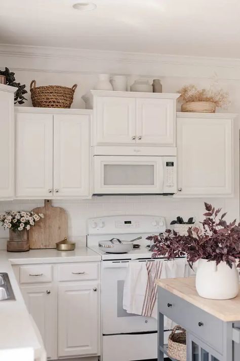 How to Decorate the Top of Kitchen Cabinets: 22 Easy Ideas - Life Glow Up Vases Above Kitchen Cabinets, Simple Decor Above Kitchen Cabinets, Top Shelf Kitchen Decor Above Cabinets, What To Put On Top Of Kitchen Cabinets, How To Decorate Kitchen Cabinets Tops, On Top Of Cabinet Decor, Baskets On Top Of Kitchen Cabinets, Styling Above Kitchen Cabinets, Top Of Cabinet Decor Kitchen