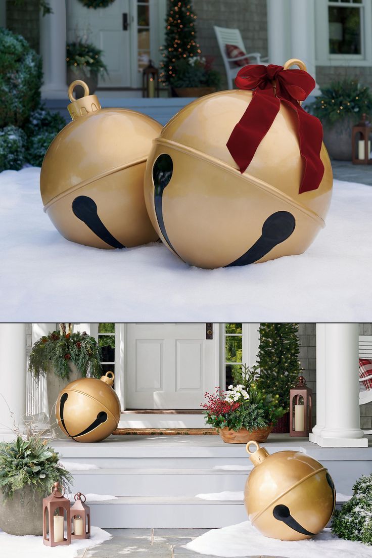 two christmas balls sitting on the steps in front of a house with a red ribbon tied around them