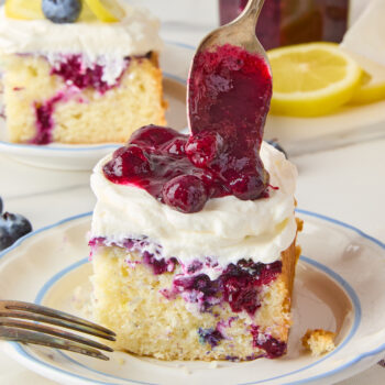 berry sauce topped over a slice of cake