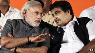 Janata Party (BJP) leader and Chief Minister of Gujarat Narendra Modi, left, speaks with party president Nitin Gadkari during a public rally in Mumbai, India.
