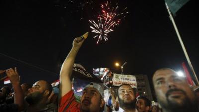 Fireworks above demonstrators in Nasr City, Cairo