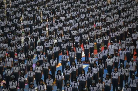 AFP School students take part in a yoga training session in Chennai on January 7, 2023.