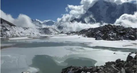 C. SCOTT WATSON/UNIVERSITY OF LEEDS A pond on the Khumbu glacier