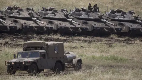 AFP Israeli Merkava tanks deployed near the Israeli-Syrian frontier in the Israeli-occupied Golan Heights (10 May 2018)