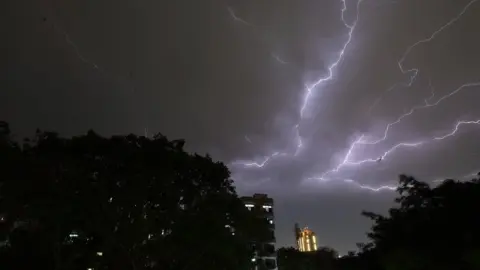 AFP Lightning strikes over residential apartments during a thunderstorm on the outskirts of the Indian capital Delhi on 2 May 2018