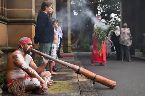 EPA Celebrations of the accession in Sydney, Australia, including an Aboriginal smoking ceremony and man playing a didgeridoo