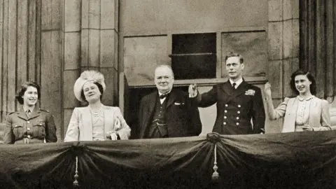 Getty Images Wartime Prime Minister Winston Churchill stands on the balcony of Buckingham Palace alongside the Royal Family (with the Queen, then Princess Elizabeth, on the left) on VE Day, 8 May 1945