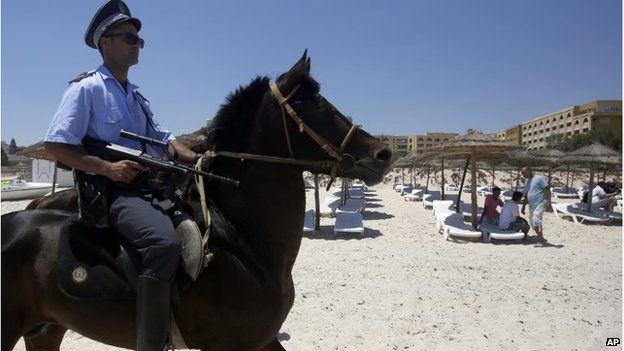 A Tunisian police officer on horse patrol the beach in front of the Imperial Marhaba Hotel in Sousse
