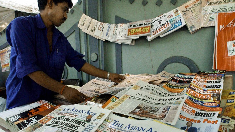 Indian newspaper vendor arranges morning editions