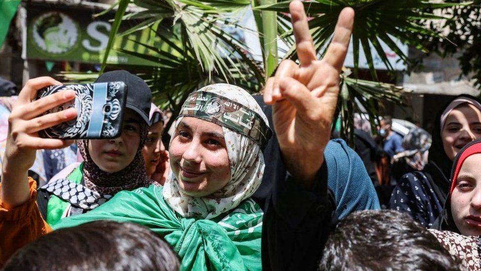 Palestinian supporters of Hamas celebrate the ceasefire between Hamas and Israel, in Khan Younis, in the southern Gaza Strip, on May 21, 2021.