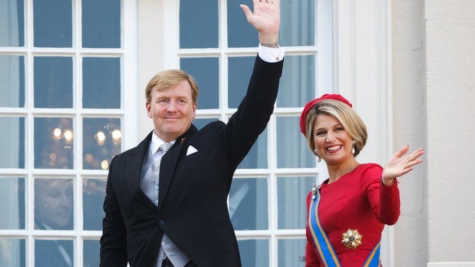 King Willem-Alexander and Queen Maxima wave from the palace balcony in The Hague
