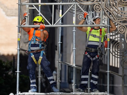 En la imagen, dos trabajadores montan un andamio en una obra en la ciudad de Valencia. EFE/Ana Escobar