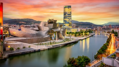 The cityscape of Bilbao at sunset, Spain. The Nervion river crosses Bilbao downtown, hosting in its margins the traditional and modern buildings of the city with  Guggenheim museum and Iberdrola tower