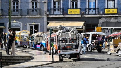Tuk-tuks parked in Camões square await the arrival of tourists in Lisbon.
