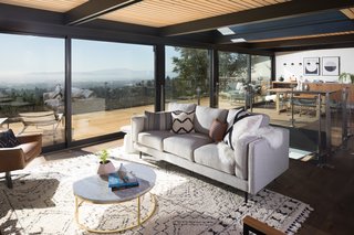 Flanking each side of a central window in the living and dining space are two massive Series 600 Sliding Glass Doors from Western Window Systems. Such large doors create a strong indoor-outdoor connection for entertaining and enjoying the bay breeze.