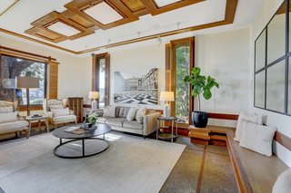 A look at the living room in the Callister-designed structure. The large room offers built-in seating, as well as custom shutters and paneling along the ceiling.  