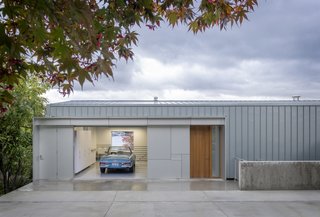 The Portage Bay Residence is a streamlined home that enjoys lake views and total privacy. The garage melds into the industrial, flat exterior, which resembles maritime sheds found throughout the area.


