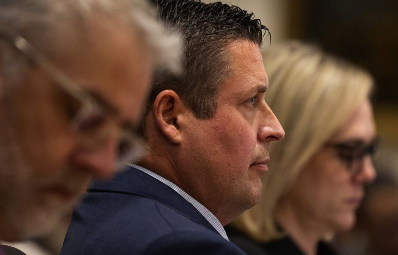 Auburn Police Officer Jeffrey Nelson, center, is flanked by two of his defense attorneys as Nelson’s trial gets underway, Thursday, May 16, 2024 in Kent. On the left is Tim Leary, to the right is Emma Scanlan.
