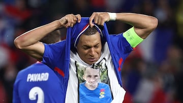 France's forward #10 Kylian Mbappe takes off his jersey to show a t-shirt in tribute to a deceased relative as he celebrates after scoring his team's third goal during the International friendly football match between France and Luxembourg at Saint-Symphorien Stadium in Longeville-les-Metz, eastern France, on June 5, 2024. (Photo by FRANCK FIFE / AFP)