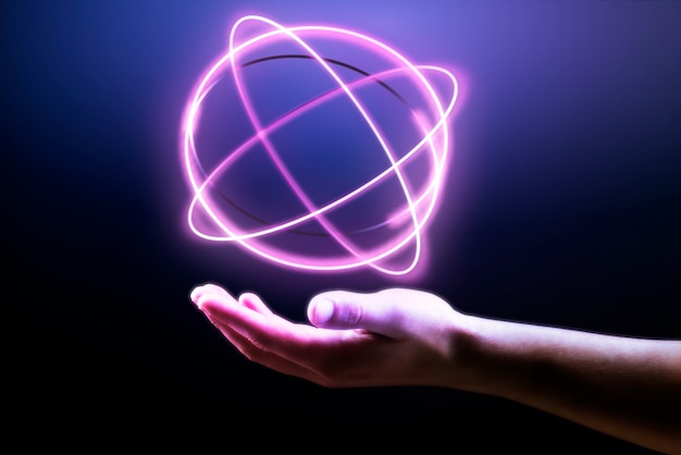 Bezpłatne zdjęcie tło hologramu atomowego pokazujące na dłoni człowieka remiks technologii nauki