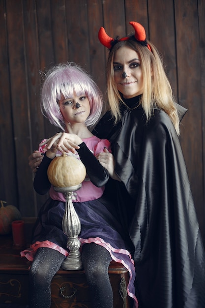 Foto grátis dia das bruxas. mãe e filha com fantasia de halloween. família em casa.