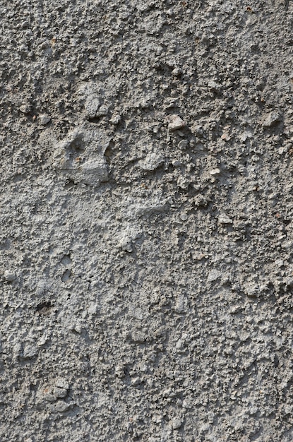 Foto textura del viejo muro de hormigón en relieve en color gris.