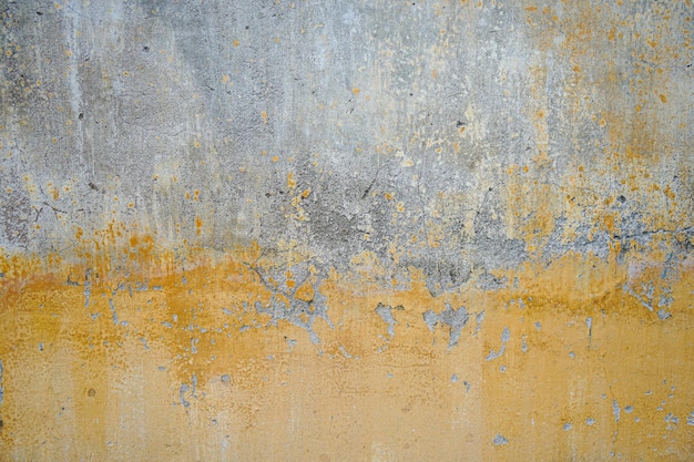 Una pared gris con pintura amarilla y naranja.