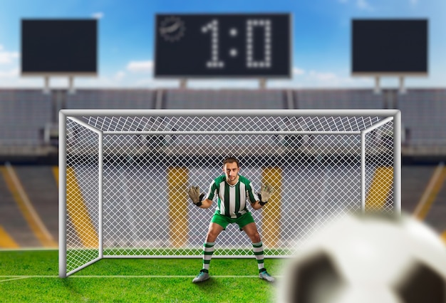 Foto portero atrapando el balón en el campo de fútbol