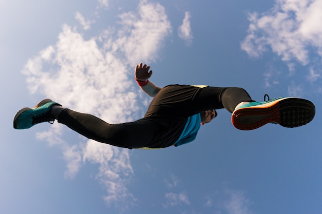 Foto gratuita deportista corre y salta al cielo